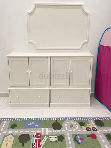 White 4-door storage cabinet with 2 bottom drawers and a matching wall-mounted decorative panel for