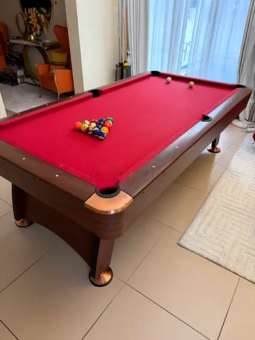 Solid wooden red-felt pool table in good condition, ready to use