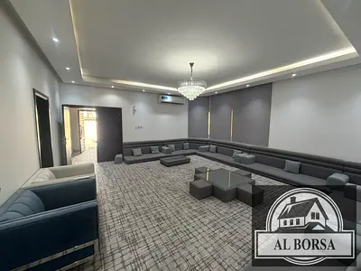 Villa for rent in Ajman, Al Rawda 3, located on an asphalt road. It features 5 master bedrooms, an external majlis with washing facilities, a spacious