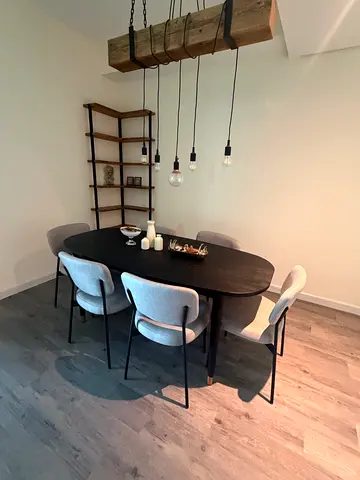 Modern round dining table with 6 upholstered chairs - dark wood finish.