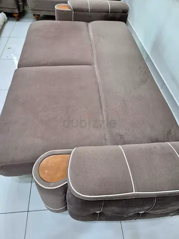 Brown fabric convertible sofa bed with armrest cup holders