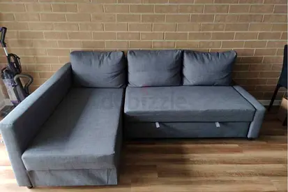 L-shaped grey fabric sofa bed with chaise lounge