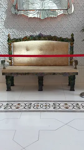 Antique wooden upholstered settee with carved frame