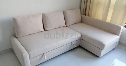 Light beige L-shaped sofa bed with storage - good condition