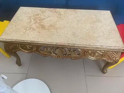 Ornate vintage-style marble top coffee table with carved gold base