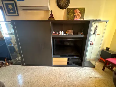 Large dark wood entertainment unit with glass display cabinets