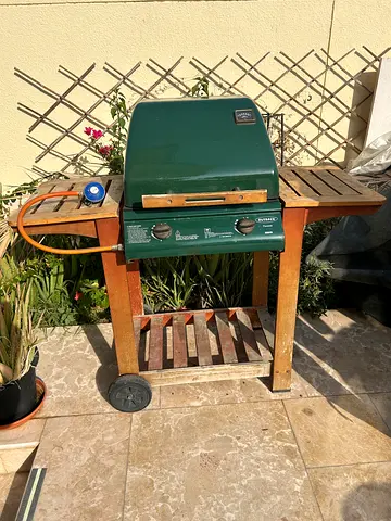 Gas BBQ Outback grill on wooden trolley.