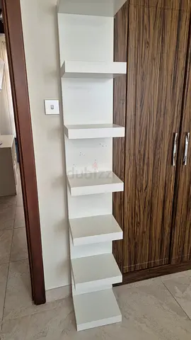 White wall-mounted display shelf with multiple compartments - good condition