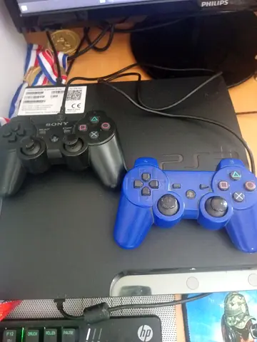 Sony PlayStation 3 Slim with 2 DualShock Controllers - Good Working Condition