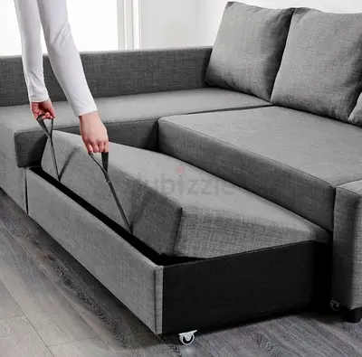 Grey L-shaped sectional sofa with pull-out bed and storage (good condition)