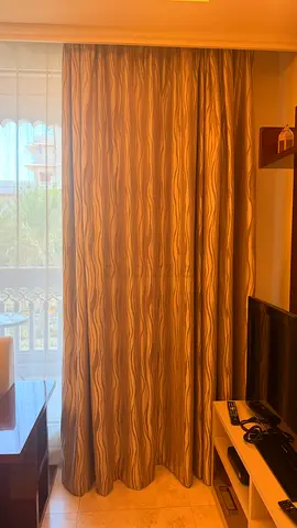 Pair of beige wavy patterned blackout curtains