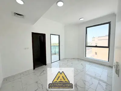 2-bedroom apartment for rent in Al Rawda 1, Ajman, behind Al Hamidiya Police Station. Spacious living room, kitchen, balcony, 3 bathrooms, central AC,