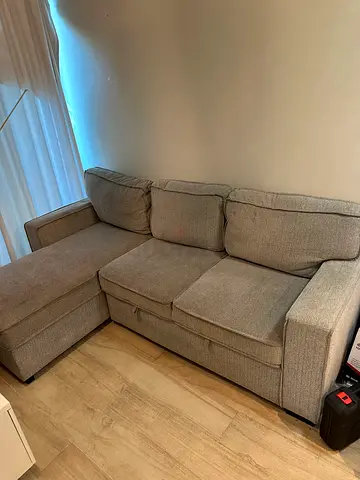 Light grey L-shaped fabric sofa, good condition