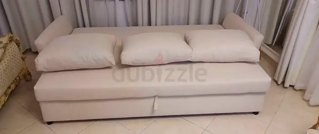 Beige upholstered sofa bed with storage - good condition
