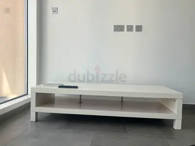 Low white TV stand / coffee table with open shelf
