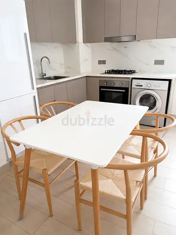IKEA-style white dining table with 4 wooden chairs