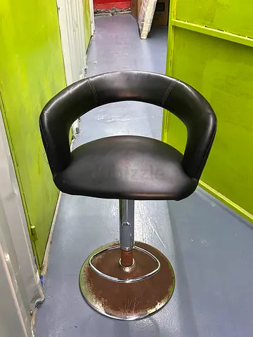 Black leather swivel bar stool with curved backrest