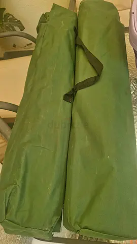 Two green folding camping cots with carry bags - never used