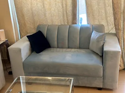 Light blue two-seater velvet sofa in good condition