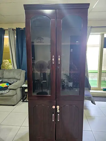 Dark wood armoire / wardrobe with glass display doors with little wear tear