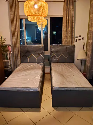 Pair of single beds with upholstered headboards - almost new