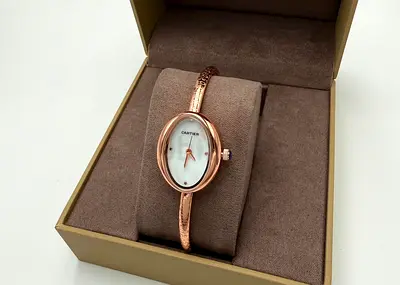 Rose gold Cartier-style ladies bangle watch in box