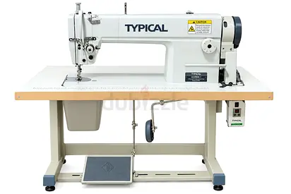 Typical industrial sewing machine with table and motor - working condition