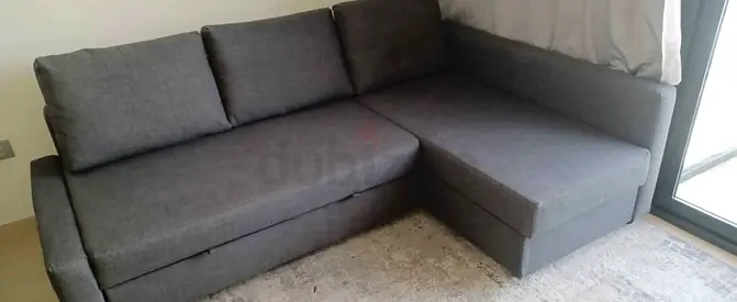 L-shaped grey fabric sofa bed with storage, good condition