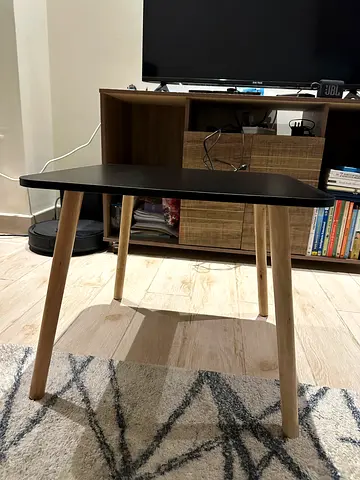 Small modern black round side table with wooden legs