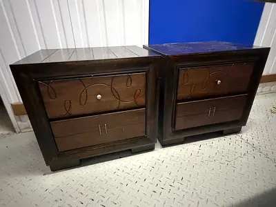 Pair of dark wood bedside cabinets with decorative front panels