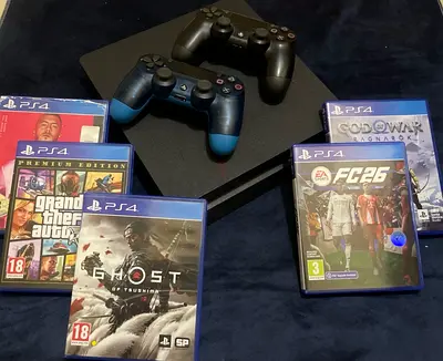 Sony PS4 Slim console with 2 controllers and 5 PS4 games