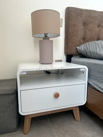 White bedside table with drawer and wooden legs - good condition