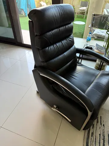 Black leather recliner armchair with chrome accents