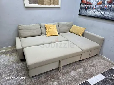 Light beige L-shaped sofa bed with storage, good condition