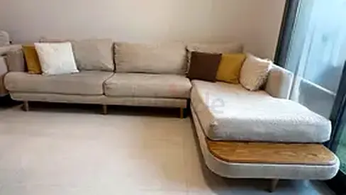 L-shaped beige fabric sofa with wooden trim — comfortable 3-seater + chaise