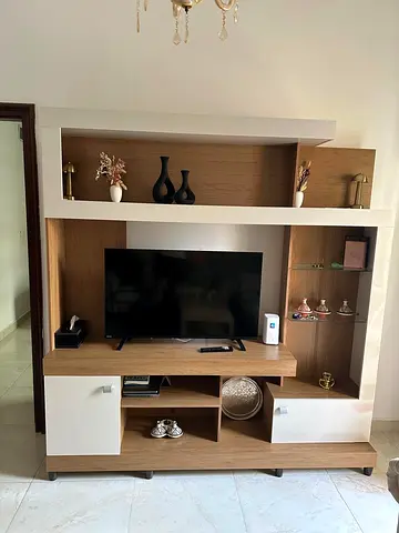 Modern wooden TV entertainment center with shelves and cabinets
