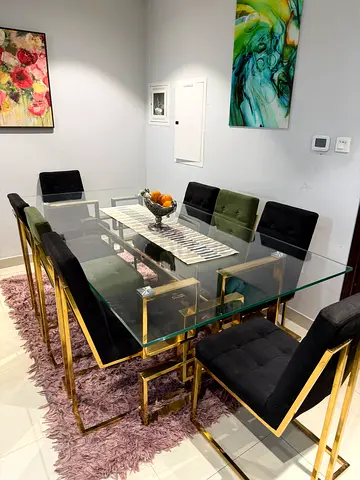 Brand new condition. Glass Top Dining Tablewith Gold Frame and Velvet Chairs (8 Seater)