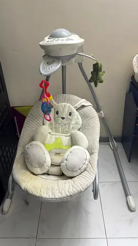 Used baby bouncer/rocker with music and toys - neutral cream