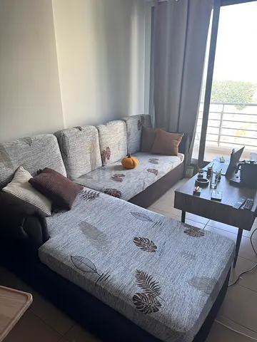 L-shaped sofa with removable patterned covers — good condition