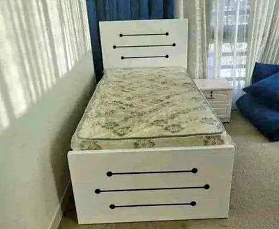 Single white wooden bed with mattress