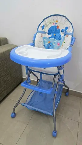 Blue baby high chair with tray and storage basket