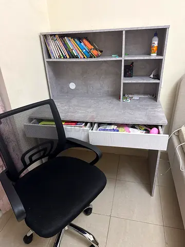 Compact study desk with storage shelves and swivel office chair