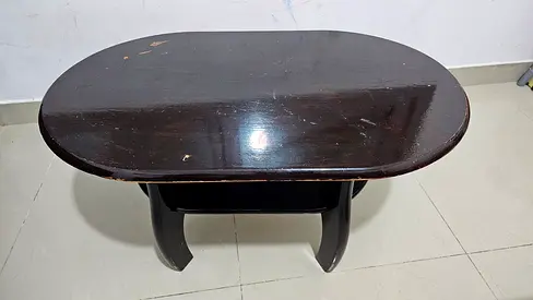Used dark wood oval coffee table with lower shelf - solid build