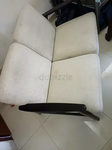 Two-seater beige fabric sofa with wooden arms - good condition