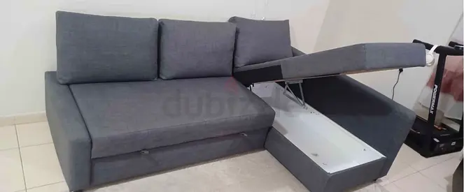 Grey fabric L-shaped sofa bed with storage - good condition