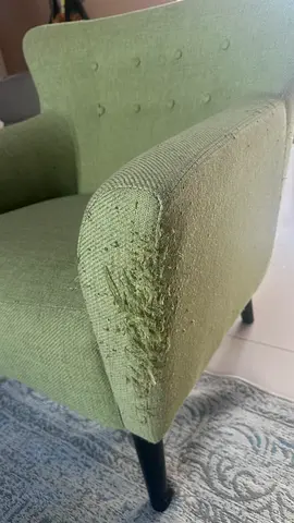 Used green fabric armchair — arm damage
