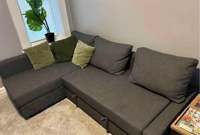 Dark grey L-shaped fabric corner sofa -bed good condition