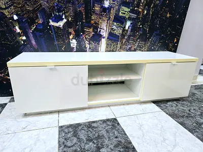 White glossy TV cabinet with storage shelves and doors