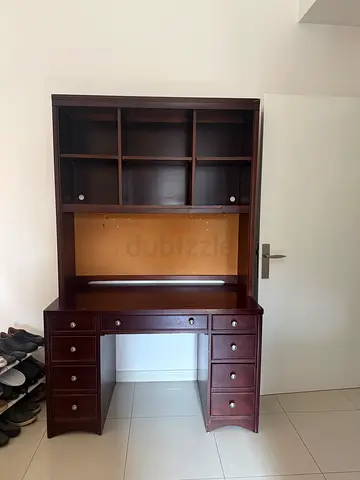 Dark wood office desk with hutch and multiple drawers