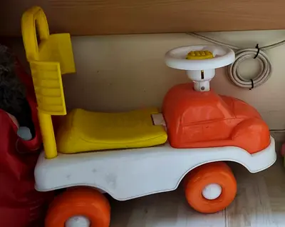 Used ride-on toddler car with steering wheel - orange/yellow
